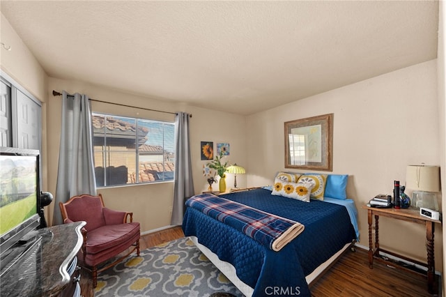 bedroom featuring a closet and dark wood-type flooring