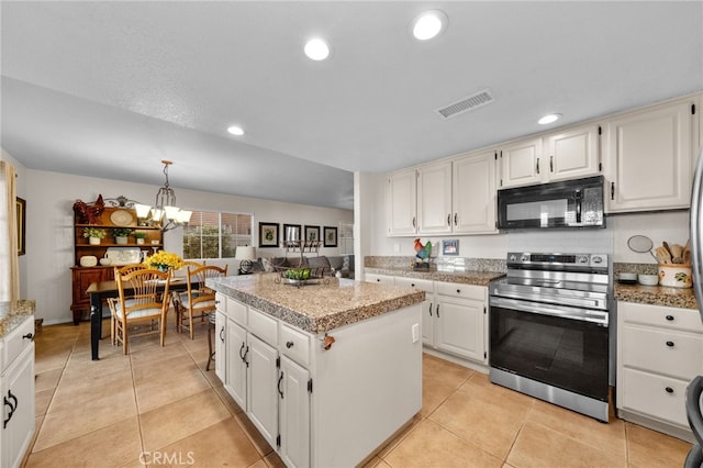 kitchen with pendant lighting, a center island, white cabinetry, stainless steel range with electric stovetop, and light tile patterned flooring