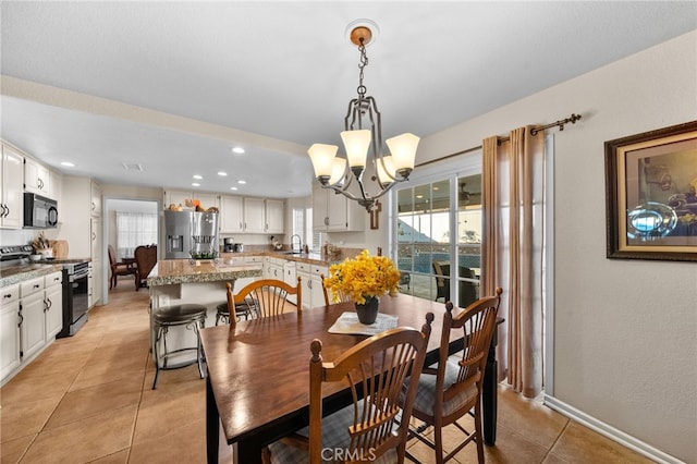 tiled dining room featuring a notable chandelier