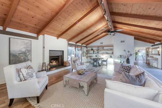 living room with wood ceiling, beam ceiling, and hardwood / wood-style floors