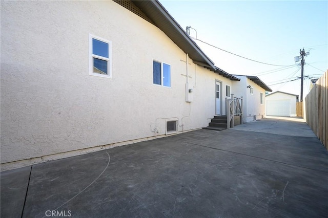 view of home's exterior featuring a garage and an outbuilding