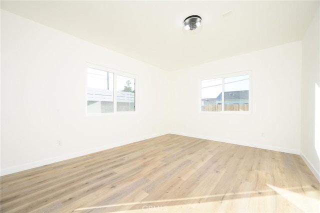 spare room with light hardwood / wood-style flooring