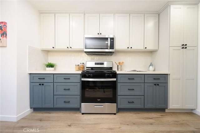 kitchen with white cabinetry, light hardwood / wood-style flooring, stainless steel appliances, and gray cabinetry