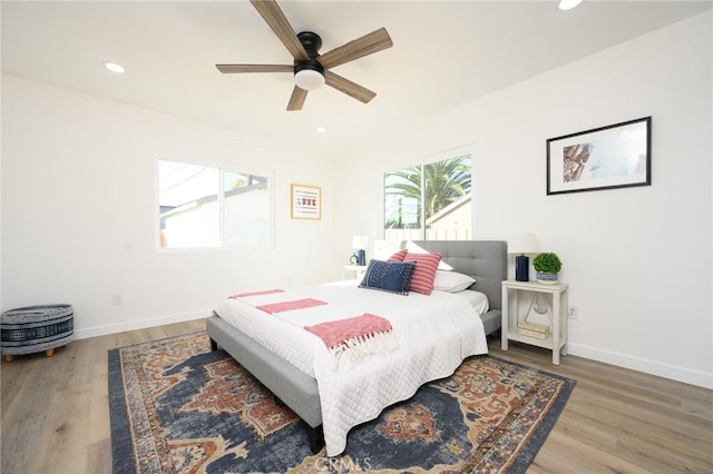 bedroom with wood-type flooring and ceiling fan