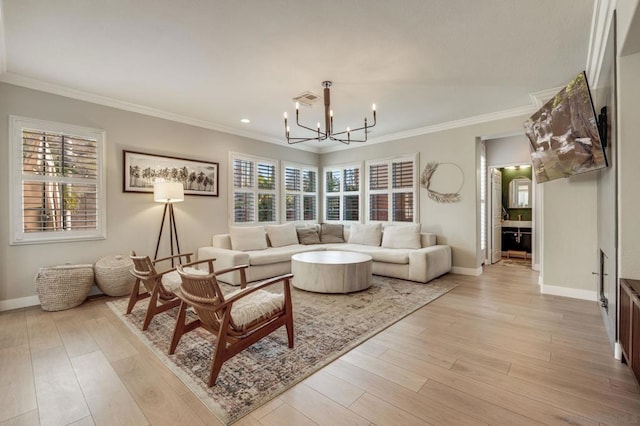 living room featuring crown molding, a chandelier, and light hardwood / wood-style flooring