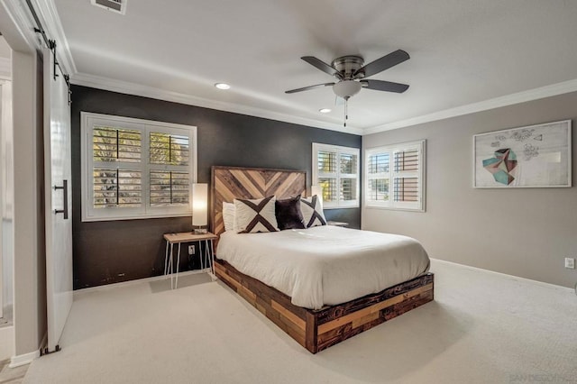 bedroom with ornamental molding, a barn door, carpet floors, and ceiling fan