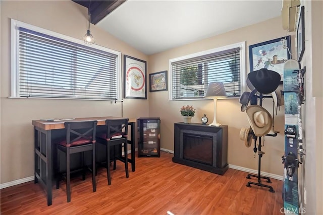 office area with lofted ceiling with beams and hardwood / wood-style floors