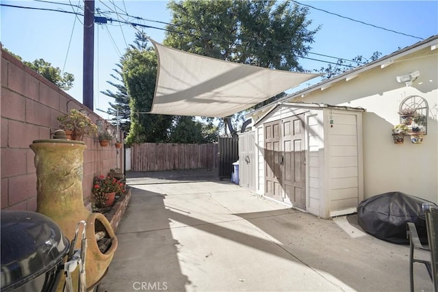 view of patio with a storage shed