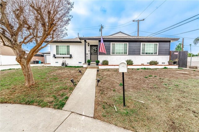 ranch-style home with a garage and a front lawn