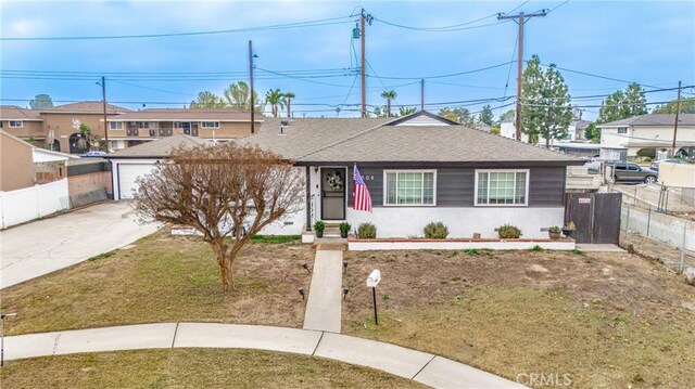 view of front of home featuring a front yard, an outbuilding, and a garage