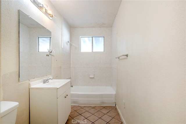 full bathroom featuring vanity, a wealth of natural light, tile patterned floors, and toilet