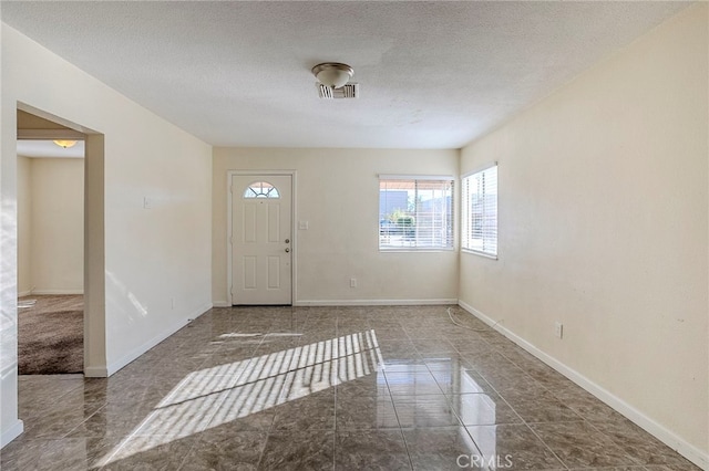 entrance foyer with a textured ceiling