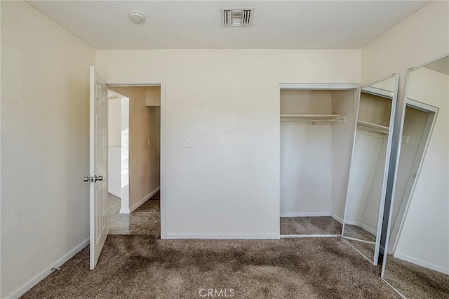 unfurnished bedroom featuring dark carpet and a closet