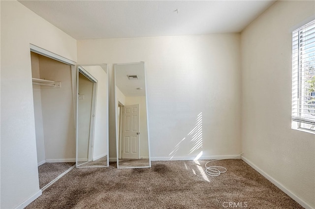 unfurnished bedroom featuring a closet and carpet