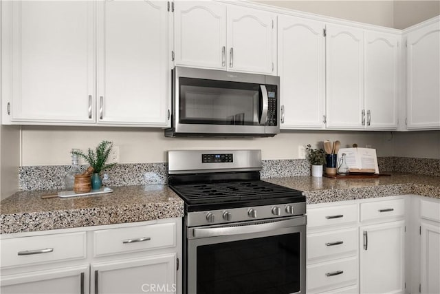 kitchen with white cabinets and appliances with stainless steel finishes