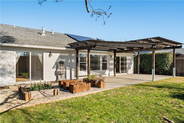 rear view of house featuring a pergola, a patio, and a lawn