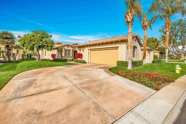 view of front of home with a garage and a front lawn