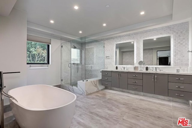 bathroom featuring vanity and shower with separate bathtub