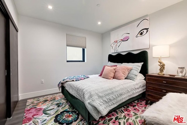 bedroom with hardwood / wood-style flooring and a closet