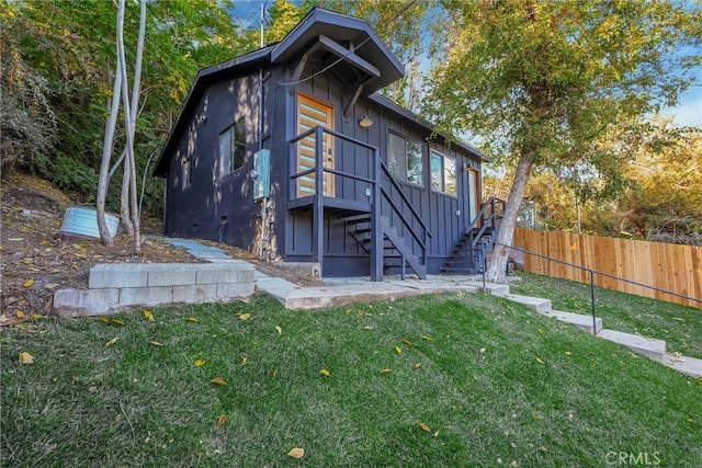 rear view of house with a yard