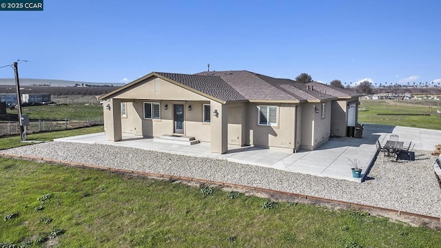 back of house with a patio and a yard