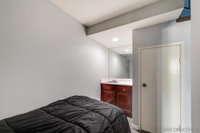 bedroom with sink and connected bathroom