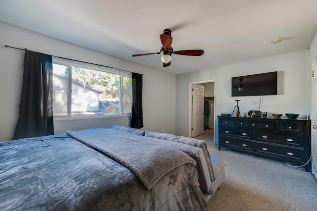 bedroom featuring light carpet, ensuite bath, and ceiling fan