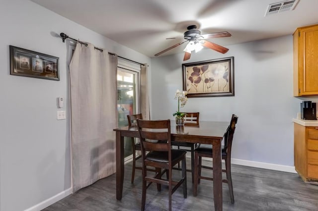 dining space featuring ceiling fan and dark hardwood / wood-style flooring