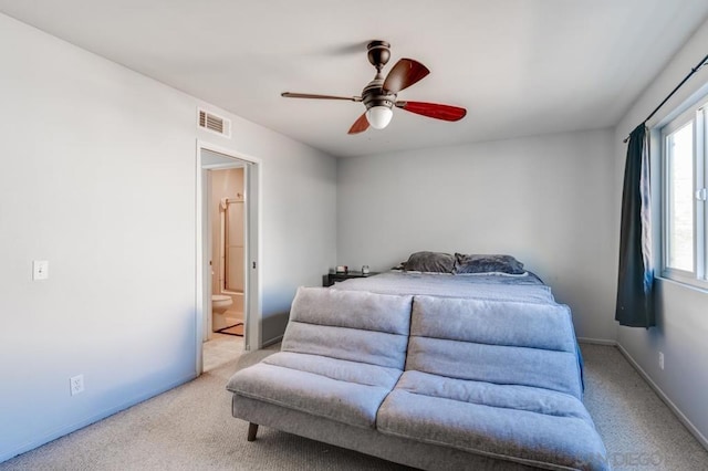 carpeted bedroom featuring ceiling fan and connected bathroom