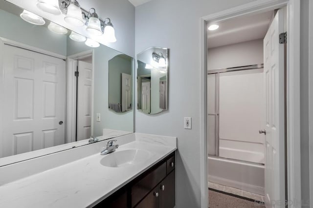 bathroom with shower / bath combination with glass door and vanity