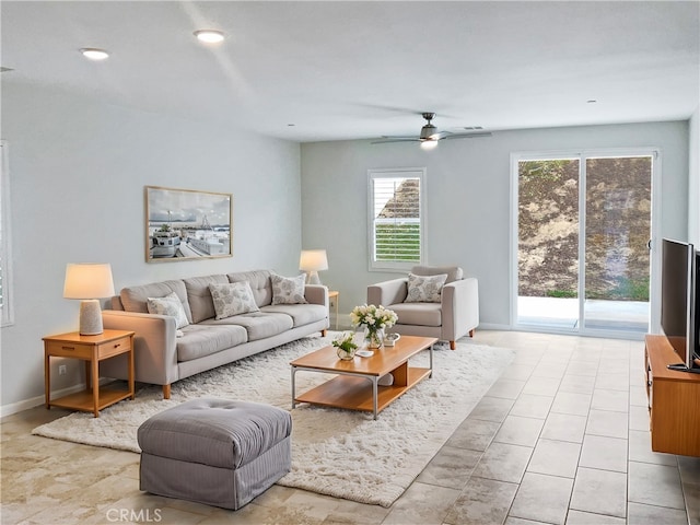 living room featuring light tile patterned floors and ceiling fan