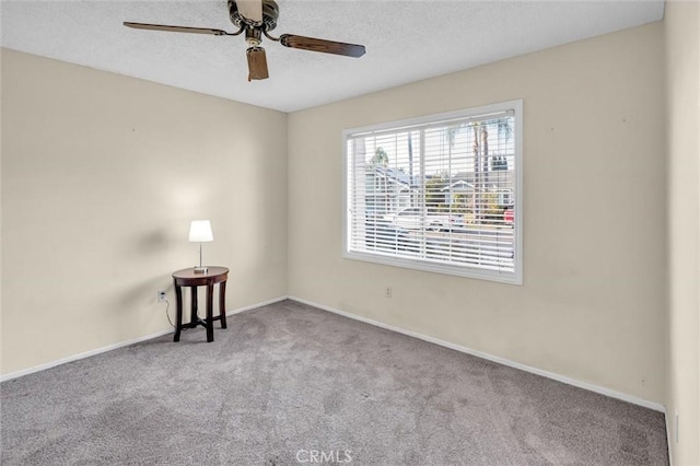 spare room featuring ceiling fan and light colored carpet