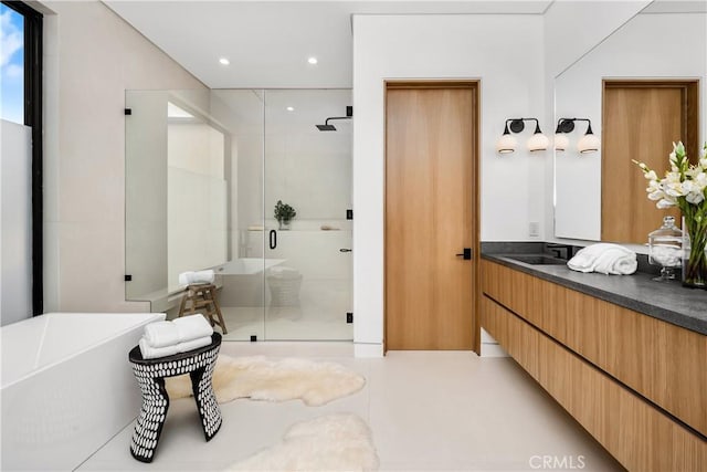 bathroom featuring vanity and separate shower and tub