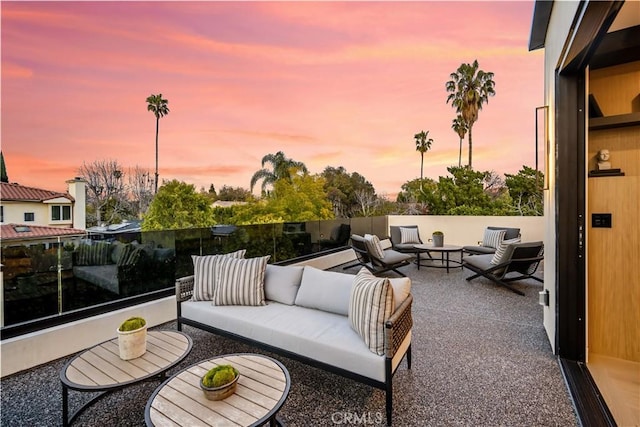 patio terrace at dusk featuring an outdoor hangout area