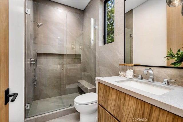 bathroom featuring vanity, toilet, and an enclosed shower