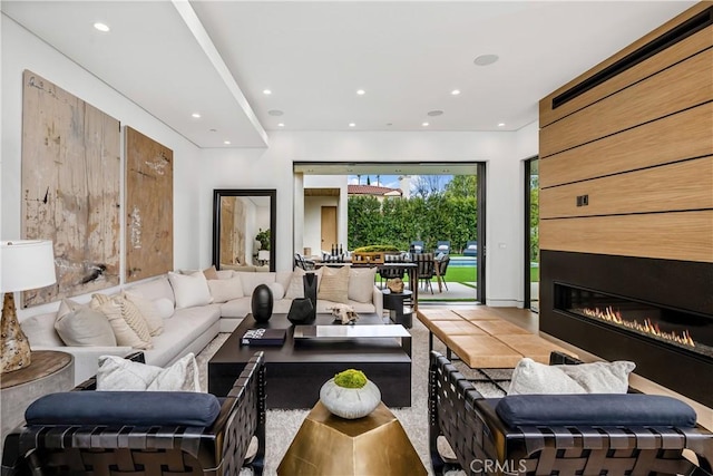 living room with a tile fireplace and tile patterned flooring