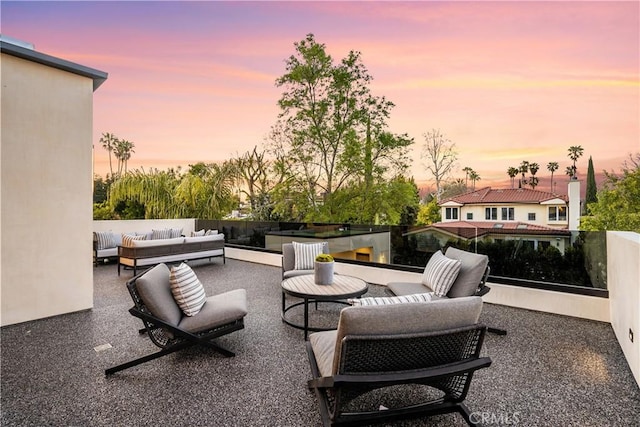 patio terrace at dusk with an outdoor living space