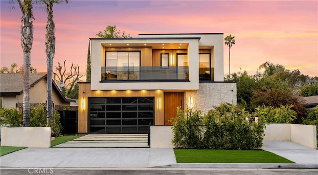 contemporary home featuring a balcony and a garage