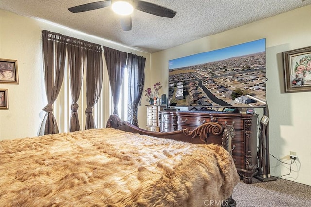 bedroom with a textured ceiling, ceiling fan, and carpet