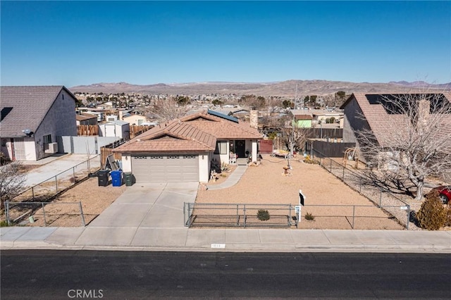 ranch-style home featuring a garage and a mountain view