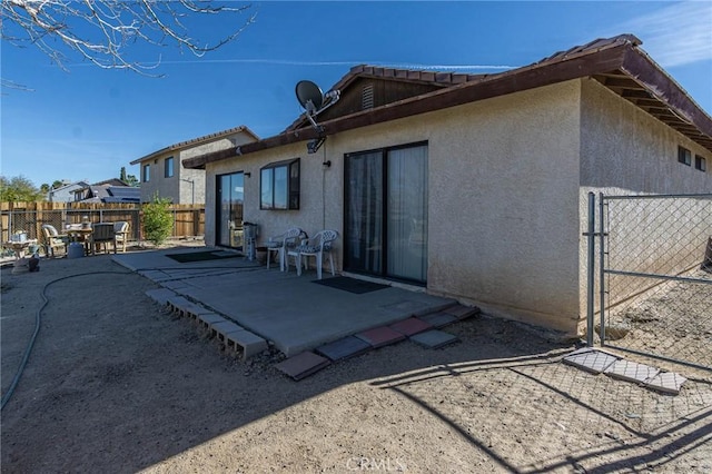 rear view of property featuring a patio area