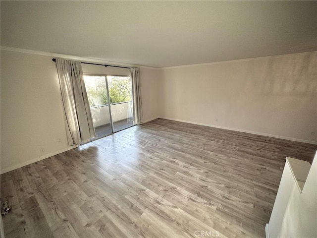 unfurnished room featuring crown molding and light hardwood / wood-style floors