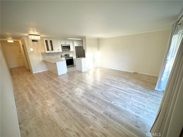 unfurnished living room featuring light wood-type flooring and crown molding