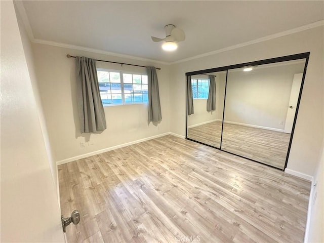 unfurnished bedroom with a closet, light wood-type flooring, and ornamental molding