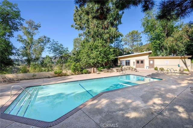 view of swimming pool featuring a patio area