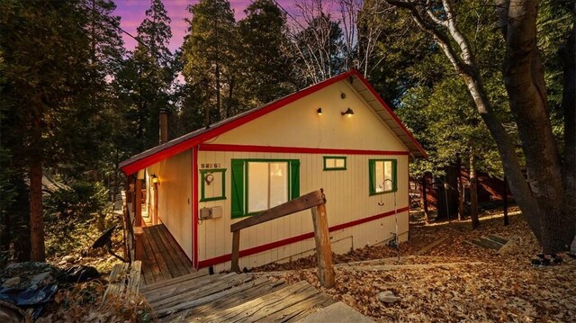 property exterior at dusk with an outbuilding