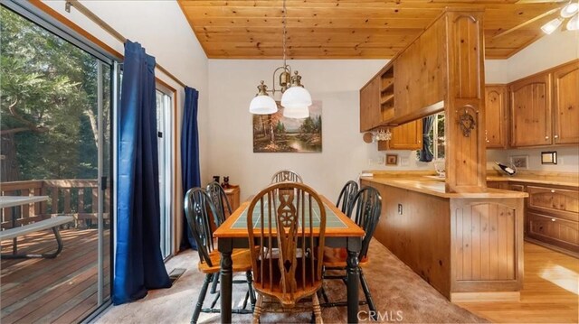 dining room featuring wooden ceiling, an inviting chandelier, lofted ceiling, and light hardwood / wood-style floors