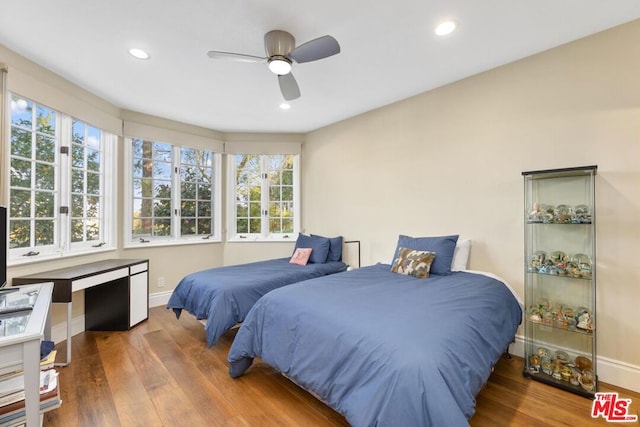 bedroom with wood-type flooring and ceiling fan