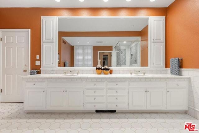 bathroom featuring vanity, tile patterned floors, and an enclosed shower