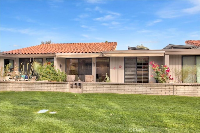 rear view of house featuring a yard